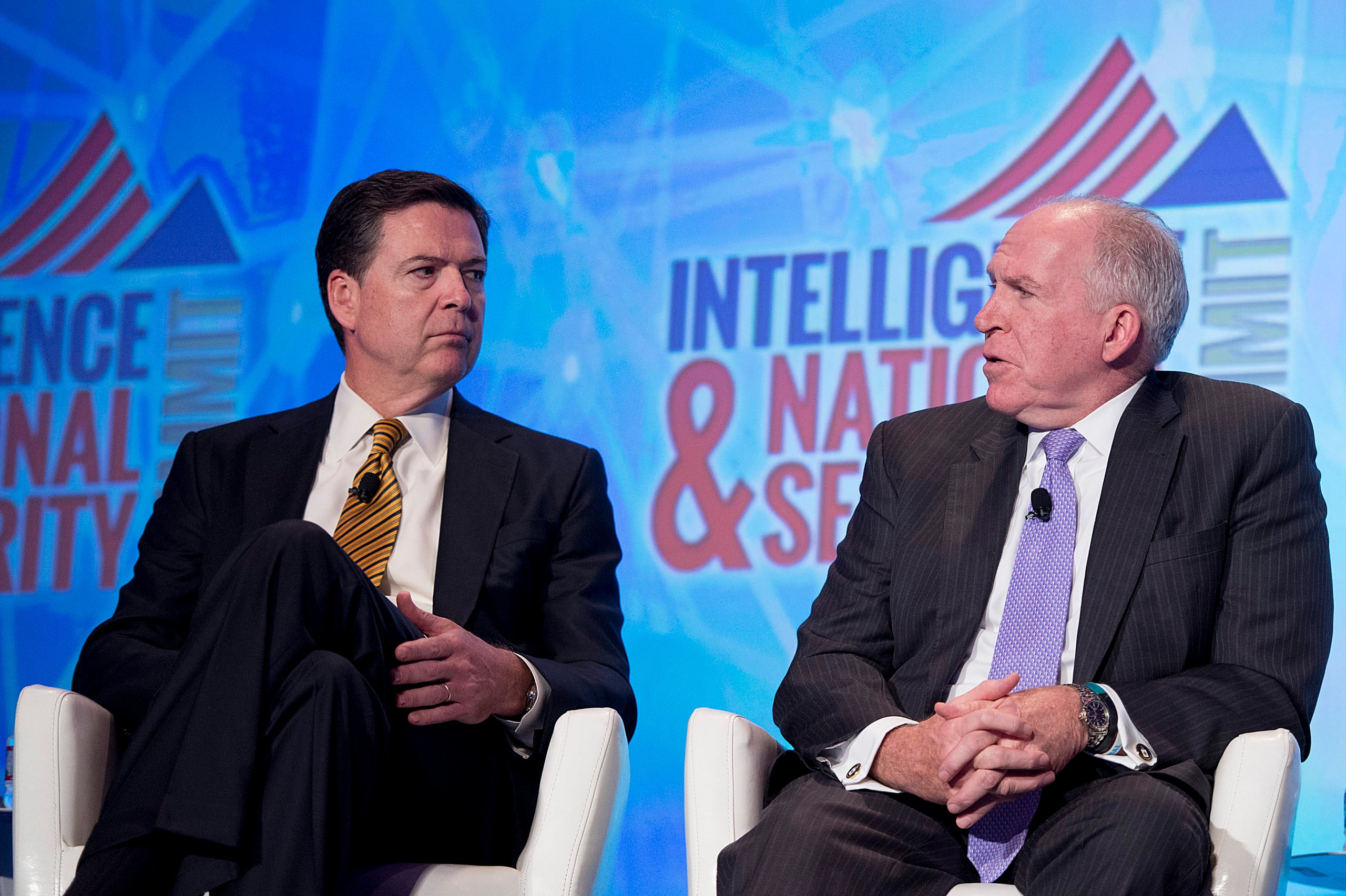 Federal Bureau of Investigation (FBI) Director James Comey (L) and Central Intelligence Agency (CIA) Director John Brennan speak at the 2016 Intelligence and National Security Summit in Washington, DC, September 8, 2016. (JIM WATSON/AFP via Getty Images)