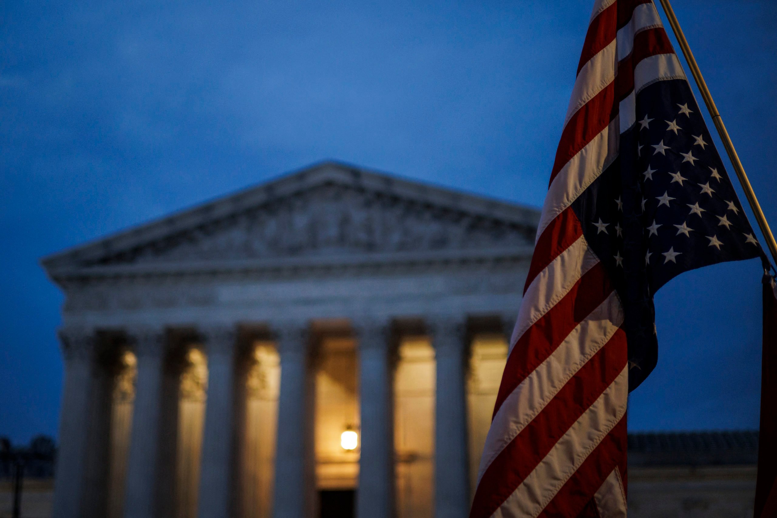 An abortion rights activist flies an upside down US flag, the international sign of distress, outside of the US Supreme Court during a protest in Washington, DC, on June 26, 2022, two days after the US Supreme Court scrapped half-century constitutional protections for the procedure. (Photo by SAMUEL CORUM/AFP via Getty Images)