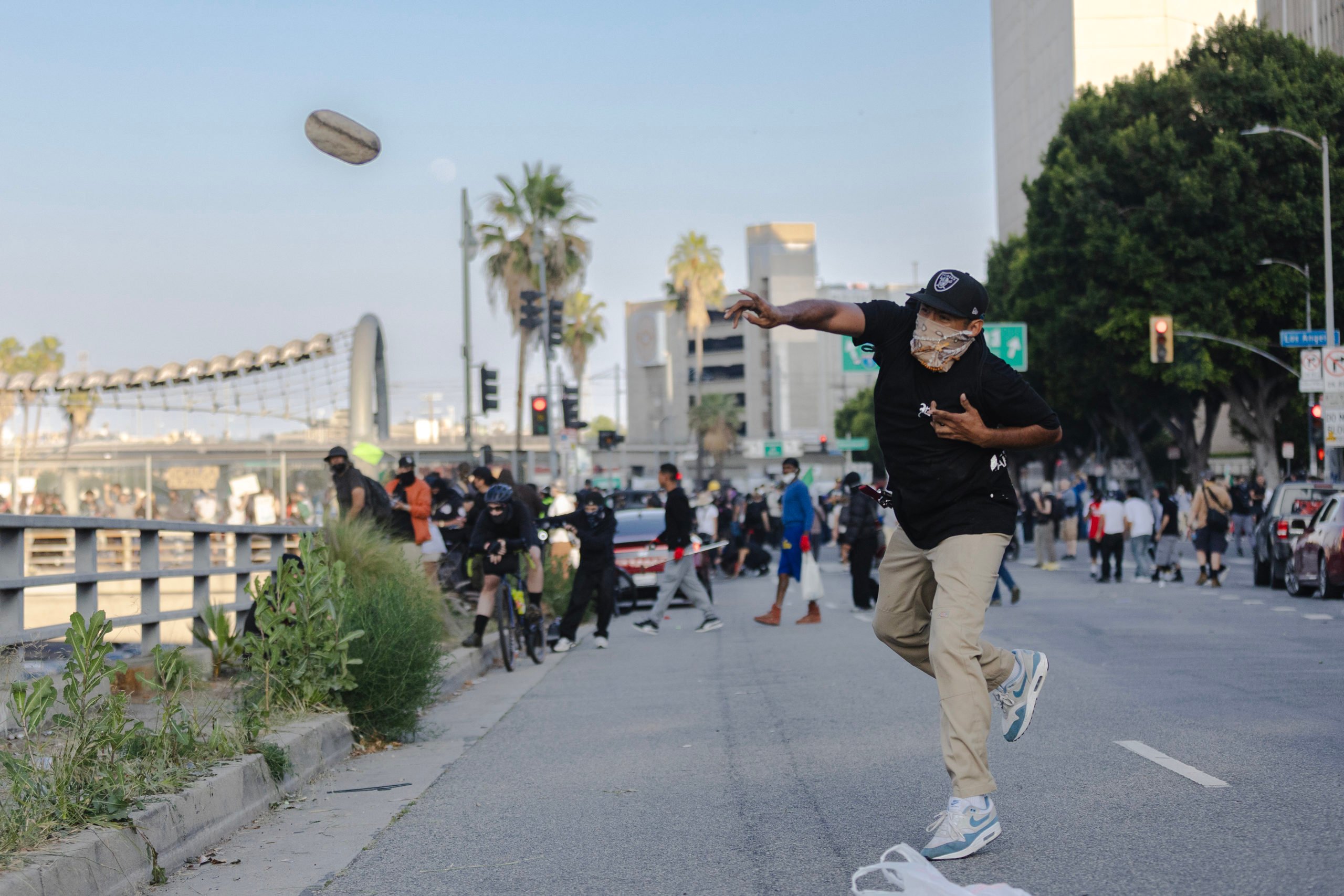 A protester throws a rock at police who were staging on the 101 freeway during clashes on June 8, 2025 in Downtown Los Angeles, California. (Photo by Jim Vondruska/Getty Images)