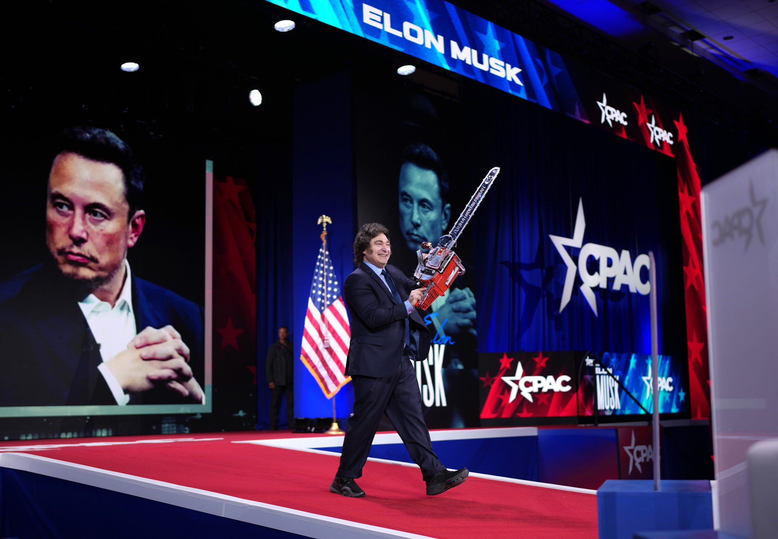OXON HILL, MARYLAND - FEBRUARY 20: Argentinian President Javier Milei wields a chainsaw as he arrives on stage at the Conservative Political Action Conference (CPAC) at the Gaylord National Resort Hotel And Convention Center on February 20, 2025 in Oxon Hill, Maryland. (Photo by Andrew Harnik/Getty Images)
