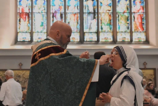 Archbishop Samuel J. Aquila of Denver distributes Communion at the Cathedral Basilica during the National Eucharistic Pilgrimage in Denver in 2024. Credit: Kate Quiñones/CNA