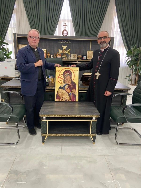 Father Benedict Kiely (left), a priest of the Personal Ordinariate of Our Lady of Walsingham, England, who has spent the last decade supporting persecuted Christians, presents the icon of Our Lady of Persecuted Christians to Bishop Benedictus Younan Hanno, Syriac Catholic archbishop of Mosul and its dependencies, Aug. 6, 2025, in Qaraqosh, Iraq. Credit: Photo courtesy of Father Benedict Kiely
