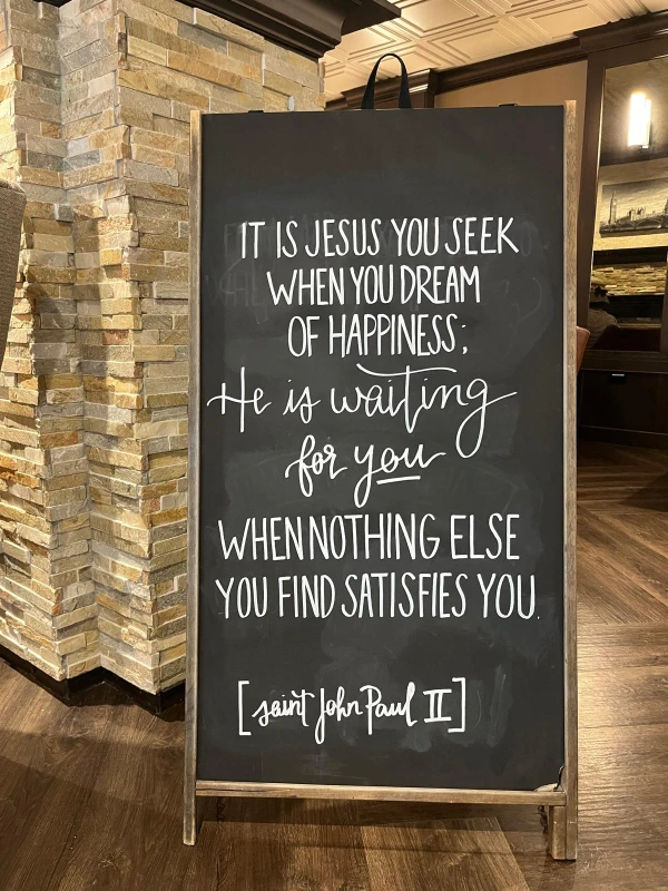 A quote from St. John Paul II is written on a chalkboard inside More Coffee. Credit: Francesca Fenton/CNA