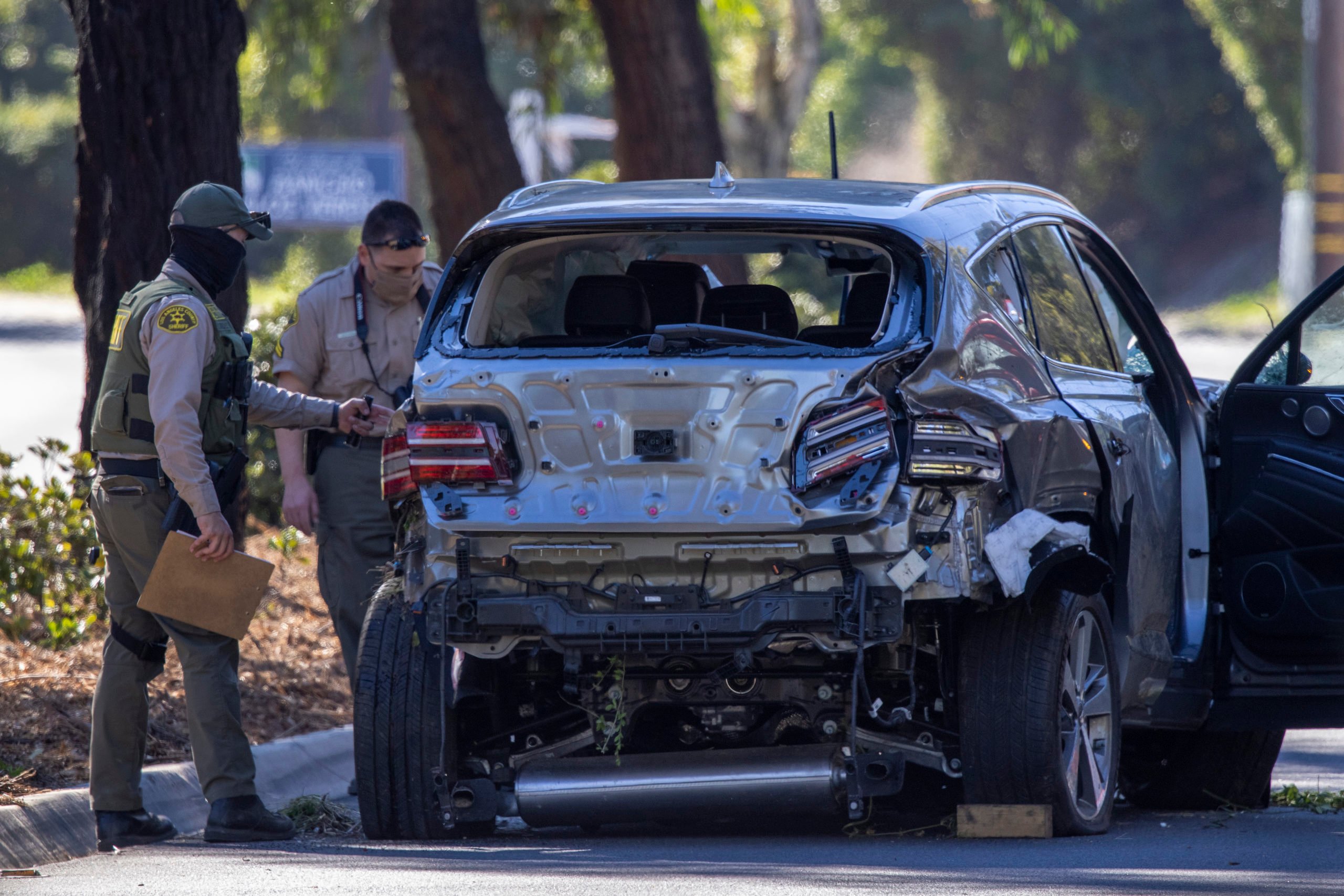 ROLLING HILLS ESTATES, CA - FEBRUARY 23: Los Angeles County Sheriff deputies gather evidence from the car that golf legend Tiger Woods was driving when seriously injured in a rollover accident on February 23, 2021 in Rolling Hills Estates, California. (Photo by David McNew/Getty Images)