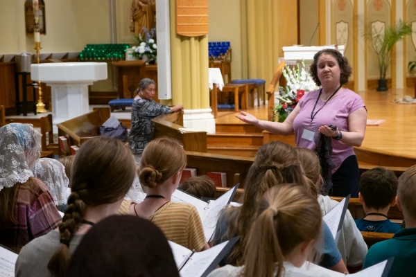 Mary Ann Wilson conducts a children's choir during Mass at St. Thomas the Apostle Parish in Ann Arbor, Michigan. Credit: Martin Barillas