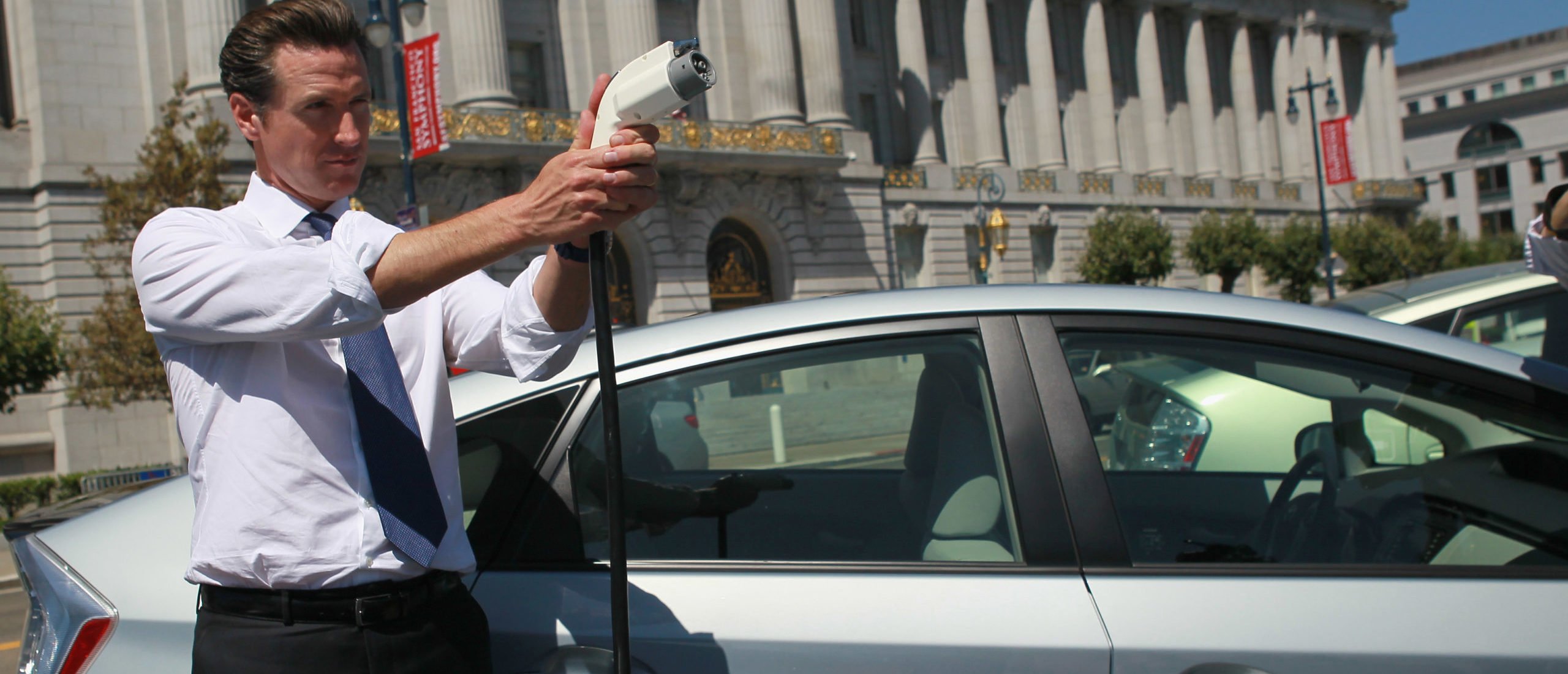 San Francisco mayor Gavin Newsom holds a power cable before test driving a plug-in version of the popular Toyota Prius that is one of four on loan to the city for evaluation August 25, 2010 in San Francisco, California. (Photo by Justin Sullivan via Getty Images)