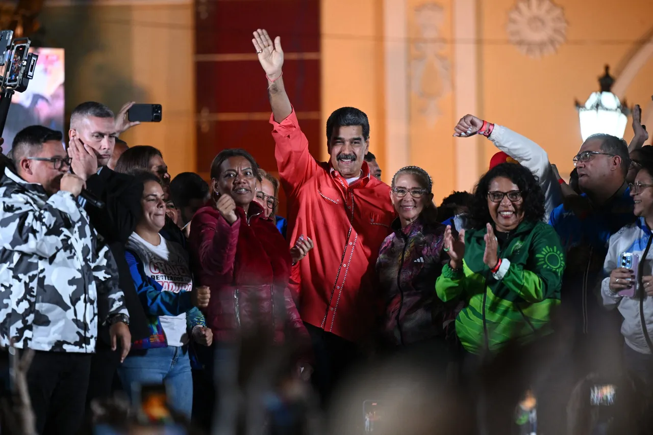 Venezuelan President Nicolas Maduro (C) waves to supporters next to his wife Cilia Flores (C-R) as he celebrates the results of the parliamentary and regional elections. (Photo by FEDERICO PARRA/AFP via Getty Images)