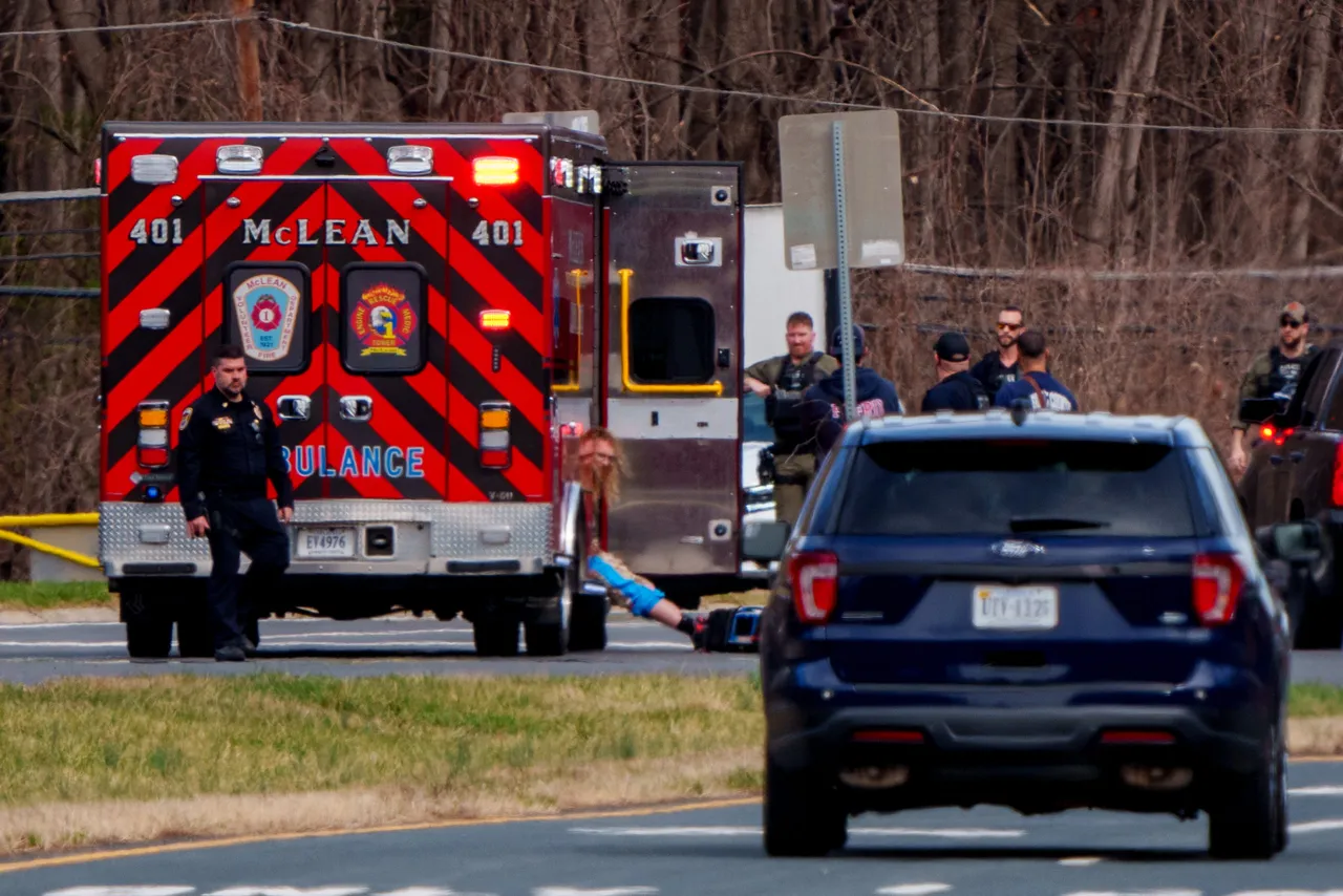 An unidentified man sits in an ambulance as members of law enforcement take him into custody after an incident near Central Intelligence Agency (CIA) headquarters on March 19, 2025. (Photo by Andrew Harnik/Getty Images)