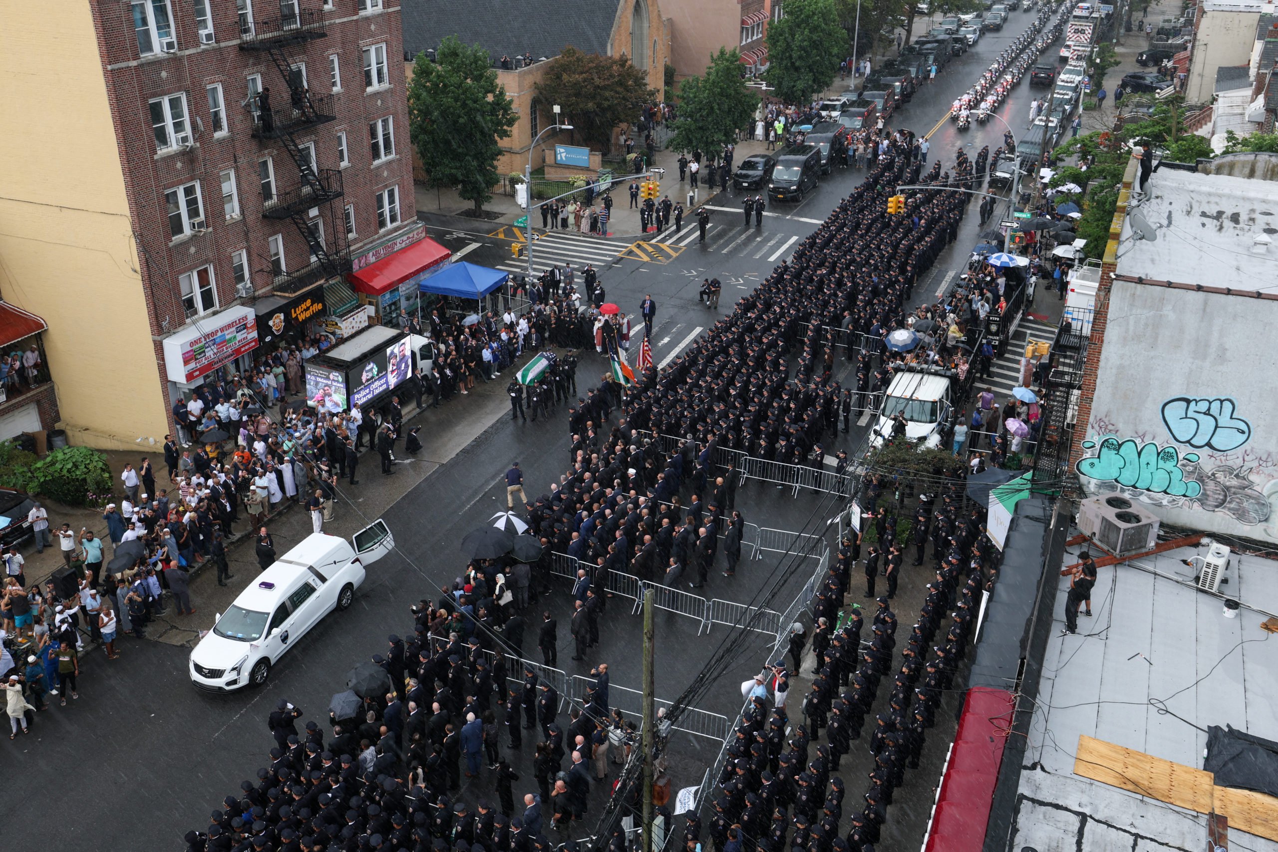 Police officers carry the casket of slain NYPD officer Didarul Islam to a hearse during Islam's funeral services in the Bronx. (Photo by TIMOTHY A.CLARY/AFP via Getty Images)