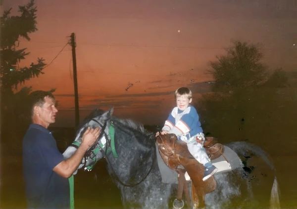 Tom Vander Woude with Josie on a horse. Credit: Photo courtesy of the Tom Vander Woude Guild