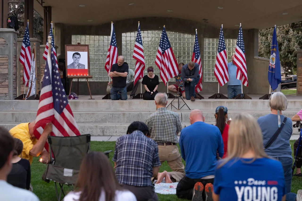 People pray as they attend a vigil for youth activist and influencer Charlie Kirk, who was shot at a public event at Utah Valley University, in Orem City Center Park, Orem, Utah, on September 10, 2025. Right-wing youth activist and influencer Charlie Kirk, a major ally of President Donald Trump, was shot dead September 10 in a 