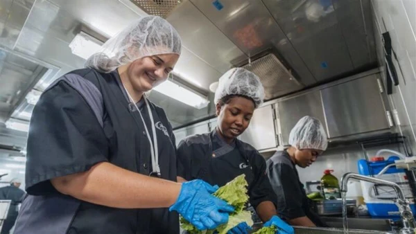 Belmont Abbey College senior nursing student Emma Harris (left) volunteers in the galley aboard the Africa Ship. Credit: Joshua Kiew Wing Chau
