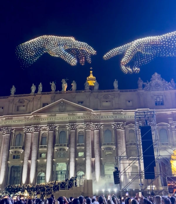 Illuminated drones reproduce a detail from Michelangelo's "Creation of Adam" above St. Peter's Basilica at the Vatican on September 14, 2025. Courtney Mares