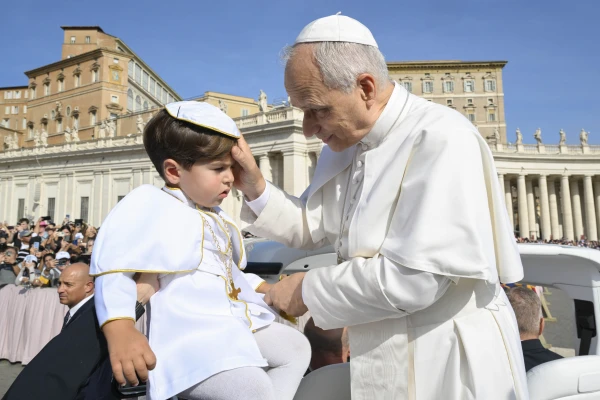Pope Leo XIV greets a child wearing a "mini pope" costume before his weekly public audience in St. Peter's Square at the Vatican on Sept. 17, 2025. Credit: Vatican Media