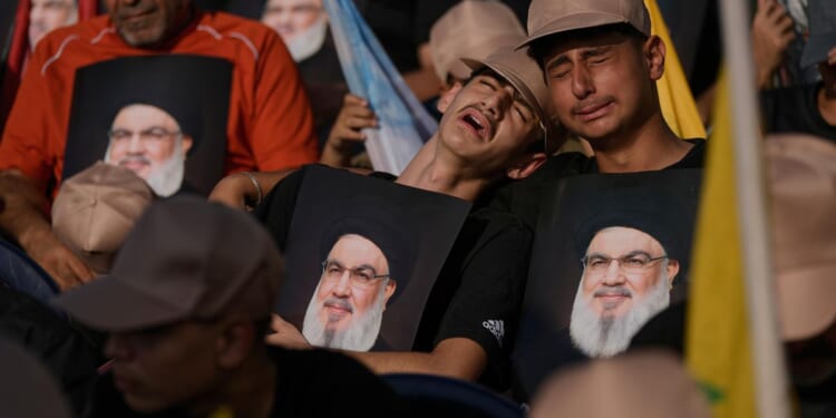 Photos show Hezbollah supporters honoring slain leaders Nasrallah and Safieddine despite PM's ban