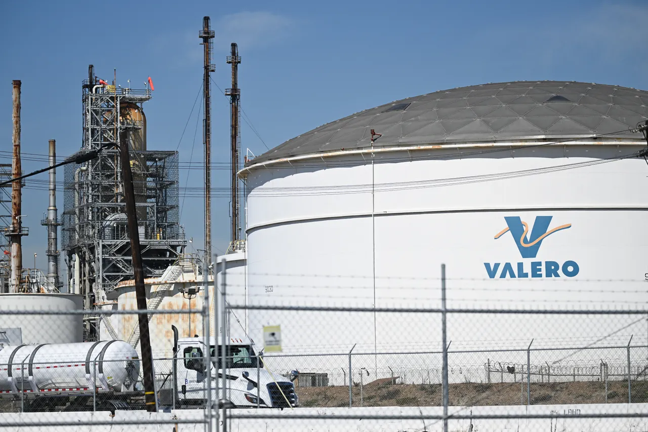 The Valero logo is displayed on a tank at the Valero Wilmington Oil Refinery adjacent to the ports of Long Beach and Los Angeles in the Wilmington neighborhood of Los Angeles. (Photo by PATRICK T. FALLON/AFP via Getty Images)