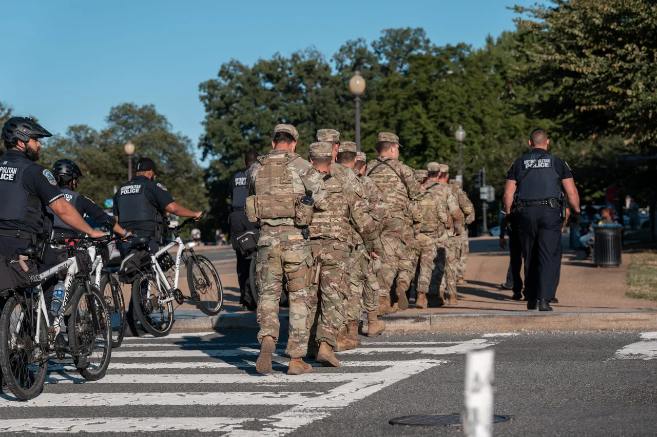 A National Guard unit leaves the National Mall under Metropolitan Police Department escort after they encountered
