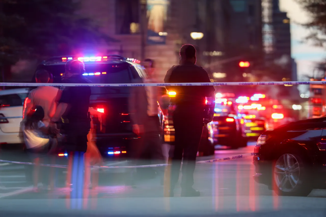 Police and others gather at a crime scene in midtown Manhattan after two people, including a police officer, were shot inside of an office building on July 28, 2025 in New York City. (Photo by Spencer Platt/Getty Images)
