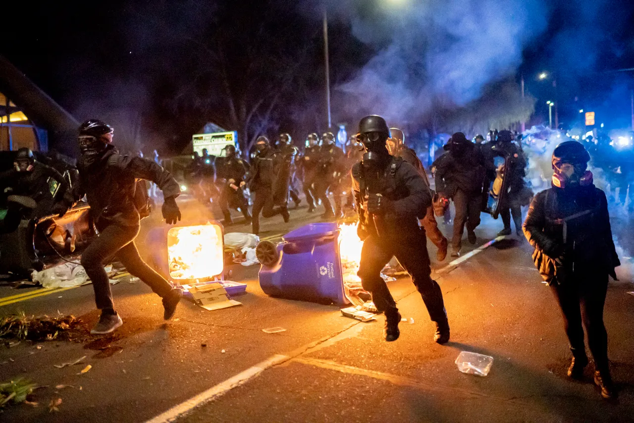 PORTLAND, OR - APRIL 12: Portland police officers chase demonstrators after a riot was declared during a protest against the killing of Daunte Wright on April 12, 2021 in Portland, Oregon. (Photo by Nathan Howard/Getty Images)