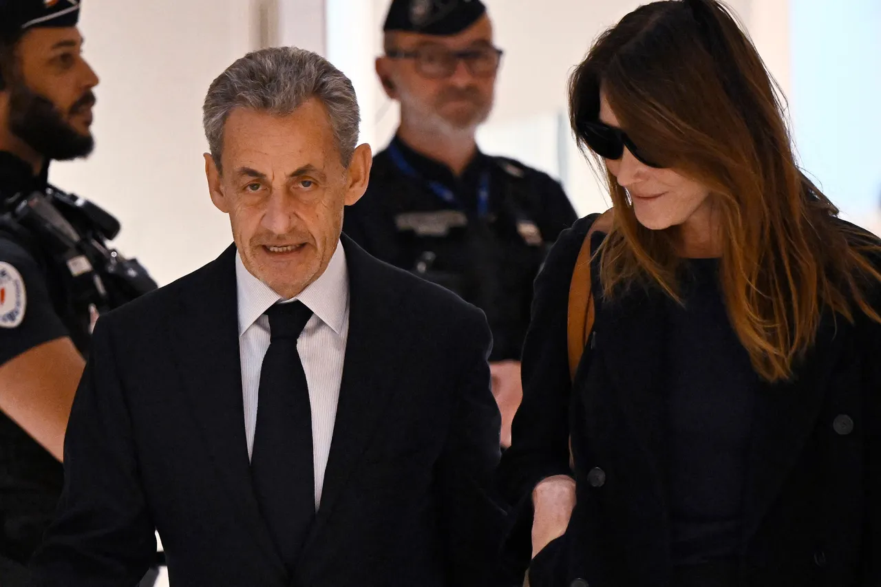 Former French president Nicolas Sarkozy with his wife Carla Bruni arrives for the verdict in his trial for illegal campaign financing from Libya for his successful 2007 presidential bid, at the Tribunal de Paris courthouse in Paris, on September 25, 2025. A Paris court is to issue its verdict on September 25, 2025 in the trial of former French president Nicolas Sarkozy and 11 co-defendants on charges of accepting illegal campaign financing from late Libyan dictator Moamer Kadhafi, with prosecutors demanding a seven-year prison sentence. The ruling is the latest in a string of legal hurdles for the right-wing ex-leader, 70, who denies the charges. Sarkozy, who was president from 2007 to 2012, has already been convicted in two separate cases and stripped of France's highest honour. (Photo by JULIEN DE ROSA / AFP)