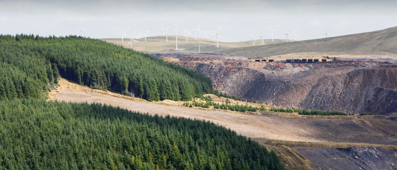 Climate change heaven and hell, The Hagshaw Hill wind farm above the Spireslack open cast coal mine in Lanarkshire, Scotland, UK. (Photo by Ashley Cooper/Construction Photography/Avalon/Getty Images)