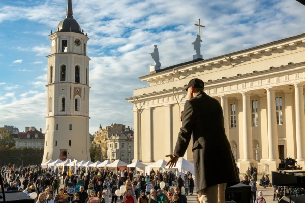 Singer Sasha Song performs onstage at Cathedral Square in Vilnius, Lithuania, with various pro-life nongovernmental organization tents visible in the background, at the March for Life, Oct. 4, 2025. Credit: Erlendas Bart