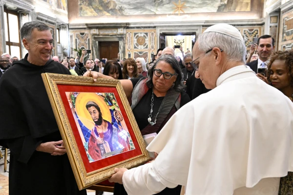Pope Leo XIV views a painting while meeting with participants attending the Oct. 1-3 Migrants and Refugees in Our Common Home summit in Rome on Thursday, Oct. 2, 2025. Credit: Vatican Media