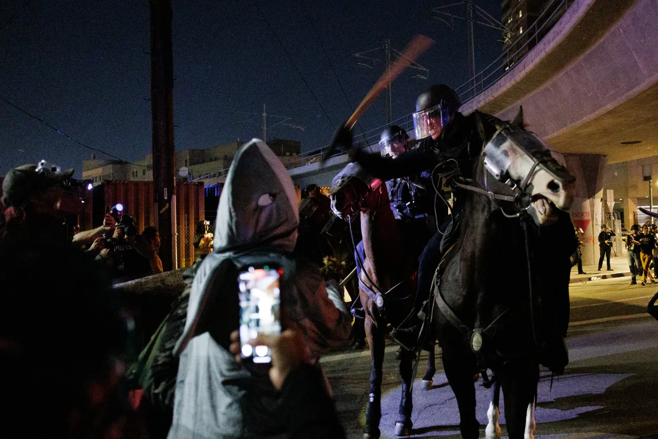LOS ANGELES, CALIFORNIA - OCTOBER 18: Protesters and mounted Los Angeles Police Department officers clash outside the Metropolitan Detection Center after an unlawful assembly was declared during the 
