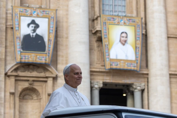 Pope Leo XIV surveys a crowd of pilgrims underneath the banners of two recently canonized saints in St. Peter's Square at the Vatican on Wednesday, Oct. 22, 2025. Credit: Daniel Ibáñez/CNA