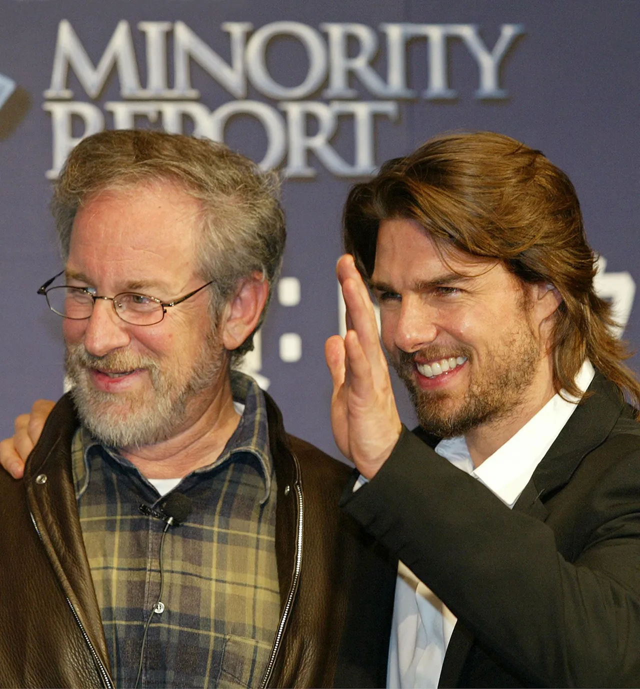 US actor Tom Cruise (R) waves as he shares a smile with director Steven Spielberg (L) during a press conference in a Tokyo hotel 26 October 2002 to promote their new movie