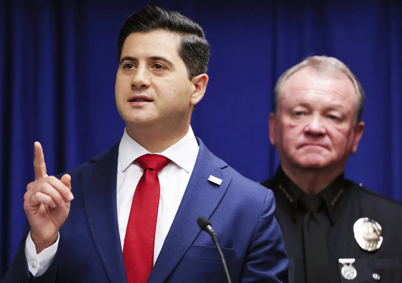 Acting U.S. Attorney Bill Essayli (L) speaks as Los Angeles Police Department Chief Jim McDonnell looks on at a press conference announcing an arrest in the Palisades Fire investigation on October 08, 2025 in Los Angeles, California. (Photo by Mario Tama/Getty Images)