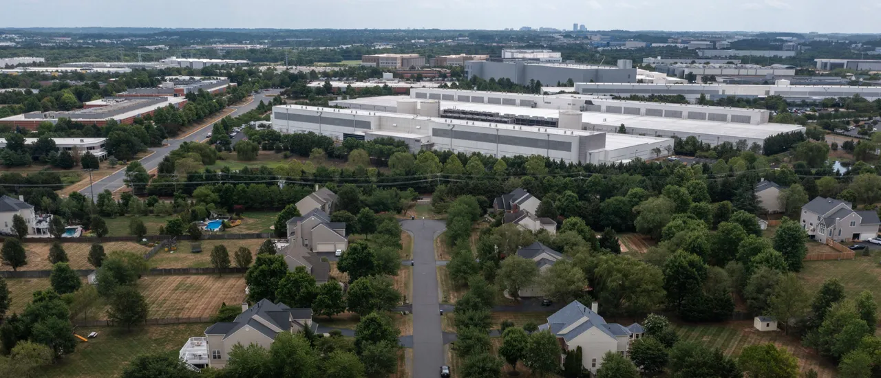 In an aerial view, various data centers are shown situated near a neighborhood on July 17, 2024 in Ashburn, Virginia. (Photo by Nathan Howard via Getty Images)