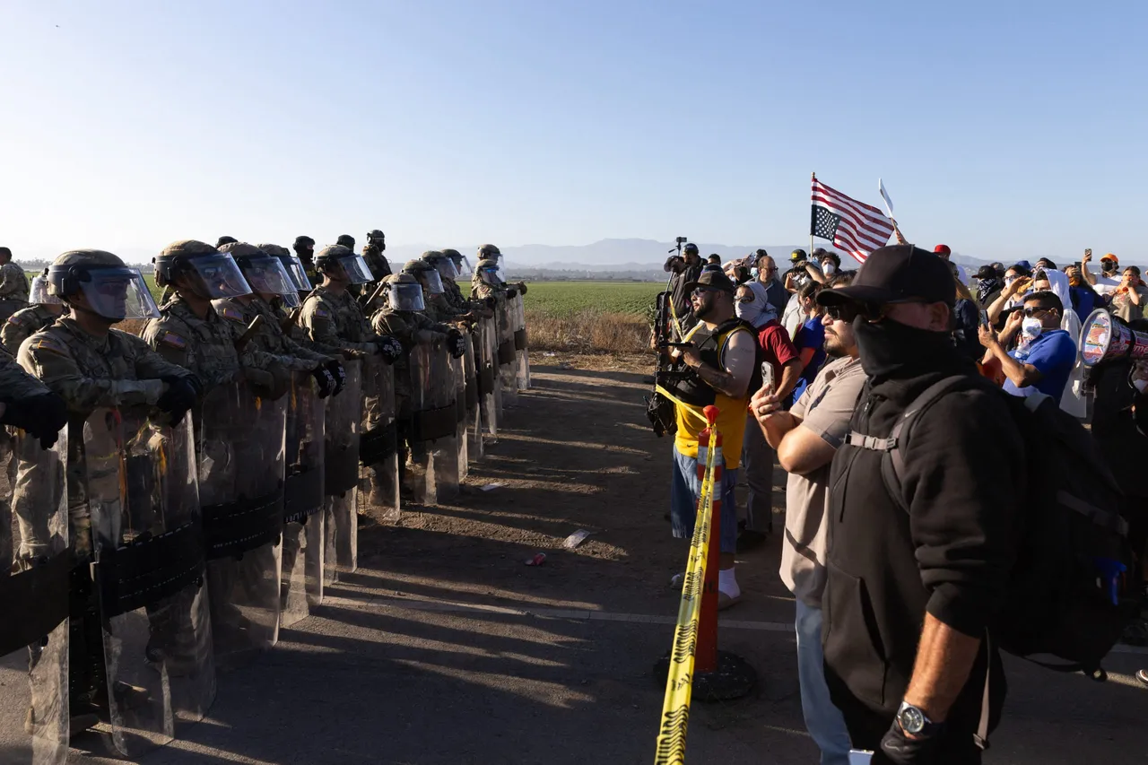 California National Guard troops face off with protestors during a Federal Immigration raid on Glass House Farms in Camarillo, California, July 10, 2025. (Photo by BLAKE FAGAN/AFP via Getty Images)