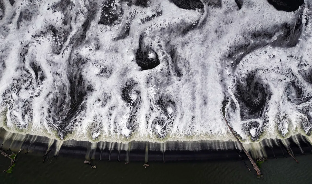 This aerial view shows sewage at the Endho dam, in Tepetitlan, Hidalgo state, Mexico on August 5, 2024. The Endho Dam, in the state of Hidalgo, is highly polluted as the Tula River, which receives sewage from Mexico City through the Central and the Eastern Discharge Tunnels, industrial waste from the Thermoelectric Plant, the Pemex Refinery, and other companies in the area, flows into it. (Photo by ALFREDO ESTRELLA/AFP via Getty Images)