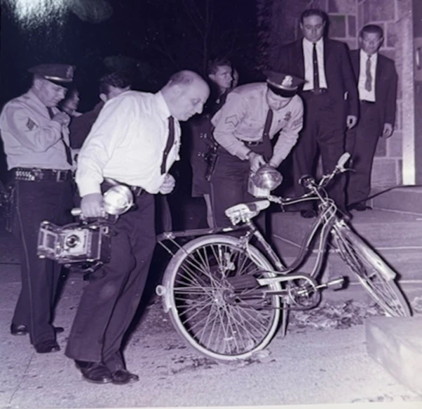 Authorities examine a bicycle after the murder of Carol Ann Dougherty in 1962. Credit: Courtesy of Buck's County District Attorney's Office.