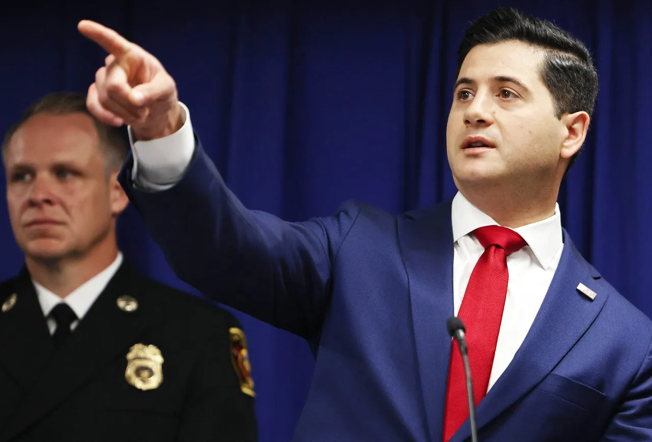 Acting U.S. Attorney Bill Essayli (R) gestures at a press conference announcing an arrest in the Palisades Fire investigation on October 08, 2025 in Los Angeles, California. (Photo by Mario Tama/Getty Images)