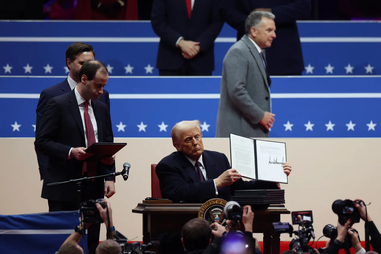 WASHINGTON, DC - JANUARY 20: U.S. President Donald Trump holds up an executive order after signing it during an indoor inauguration parade at Capital One Arena on January 20, 2025 in Washington, DC. Donald Trump takes office for his second term as the 47th president of the United States. (Photo by Tasos Katopodis/Getty Images)