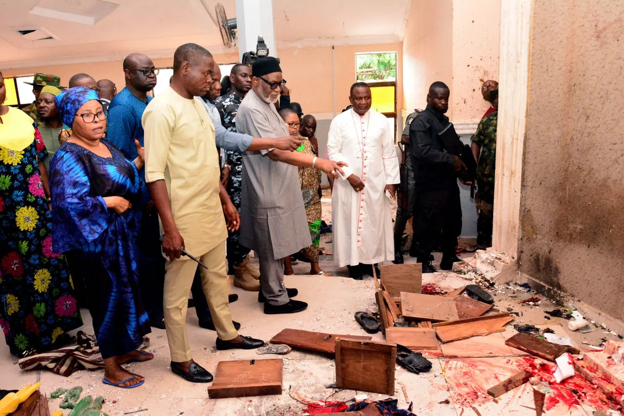 EDITORS NOTE: Graphic content / TOPSHOT - Ondo State governor Rotimi Akeredolu (3rd L) points to blood the stained floor after an attack by gunmen at St. Francis Catholic Church in Owo town, southwest Nigeria on June 5, 2022. - Gunmen with explosives stormed a Catholic church and opened fire in southwest Nigeria on June 5, killing 