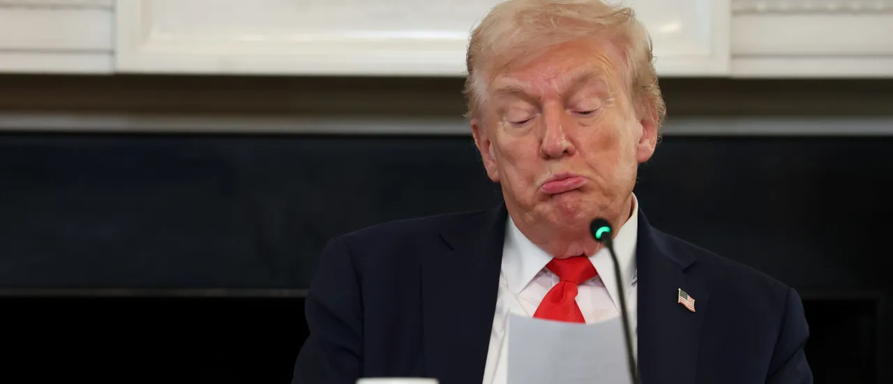 U.S. President Donald Trump reads a note handed to him by U.S. Secretary of State Marco Rubio he said was regarding Middle East peace talks during a roundtable discussion in the State Dining Room of the White House on October 08, 2025 in Washington, DC. Trump’s administration held the roundtable to discuss the anti-fascist Antifa movement after signing an executive order designating it as a 