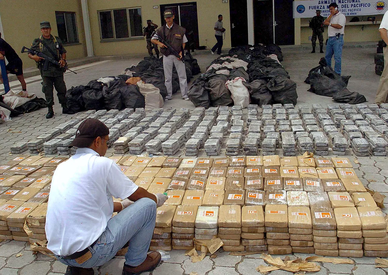 Police officers watch over 13.5 tones of cocaine 13 May 2005, confiscated during a joint police-navy raid on a processing laboratory outside the Pacific port of Tumaco, near the border with Ecuador, in what Colombian authorities say is the country's biggest single narcotics haul. Five people were arrested, and officials confiscated eight vessels, nine rifles and 22,050 litres of chemicals used to extract cocaine from coca plant leaves. Right wing paramilitaries and leftist Revolutionary Armed Forces of Colombia (FARC) guerrillas are active in the region. Both groups use drug trafficking as a source of revenue. AFP PHOTO/ EL PAIS (Photo by STR/AFP via Getty Images)