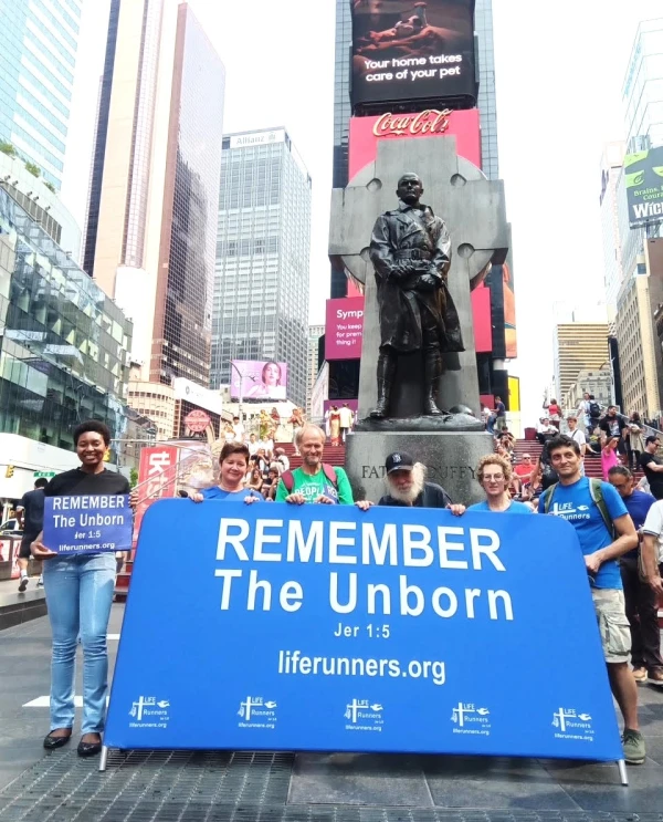 New York City kickoff for the A-Cross America Relay. Participants prayed and then walked with the big “REMEMBER The Unborn” banner to the Father Francis Duffy statue in Times Square. Credit: Photo courtesy of LIFE Runners.