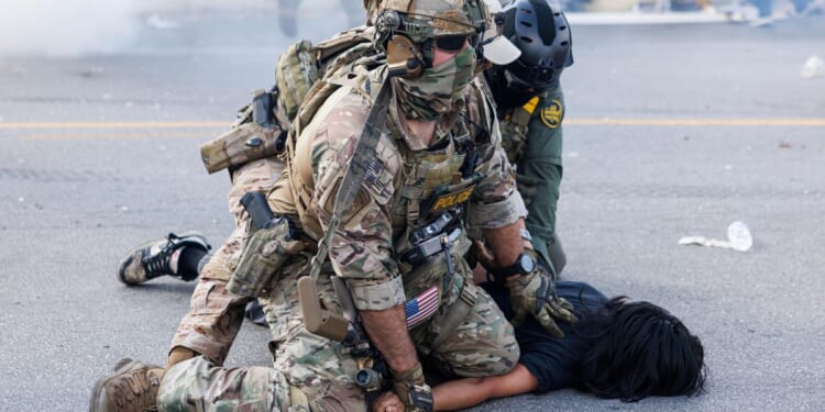 Video shows immigration agent punching restrained man after car collision turns into confrontation