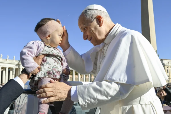 Pope Leo XIV blesses a baby in St. Peter’s Square during his general audience on Wednesday, Nov. 5, 2025, at the Vatican. Credit: Vatican Media