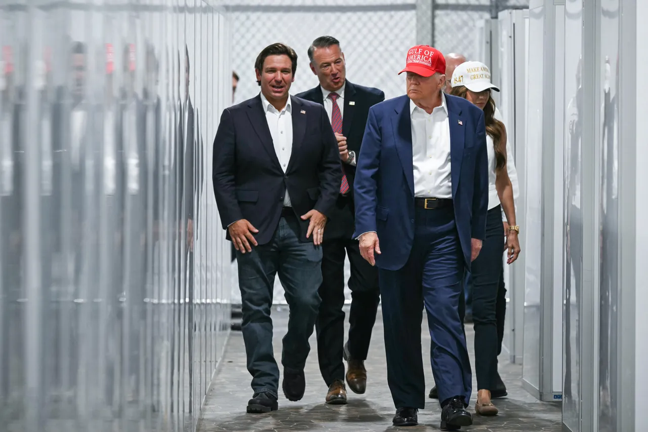 US President President Donald Trump (2R), Florida Governor Ron DeSantis (L), and Secretary of Homeland Security Kristi Noem (R) walk through a medical facility section as they tour a migrant detention center, dubbed 