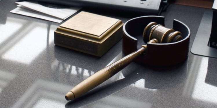 Ex-college professor charged with killing wife after being caught in 'sextortion' scam