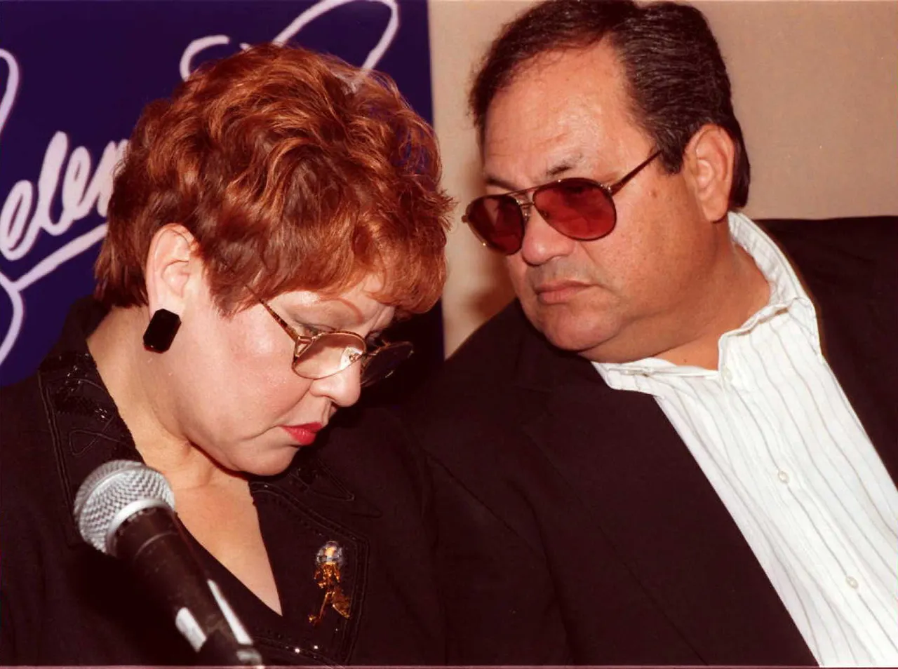 BEVERLY HILLS, UNITED STATES: The parents of deceased Tejano singer Selena, Marcella and Abraham Quintanilla Jr. (R), confer at a press conference in Beverly Hills 18 June. The press conference was held to reveal the stars of the upcoming Warner Brothers Studio movie about Selena. AFP PHOTO Tiziana SORGE (Photo credit should read TIZIANA SORGE/AFP via Getty Images)