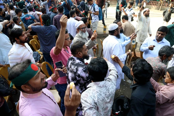 On Nov. 17, 2025, a death sentence was handed down in the wake of the charges of genocide against humanity against the ousted Bangladeshi Prime Minister Sheikh Hasina. As soon as the verdict was announced, people began distributing sweets in the Dhaka University area. Credit: Stephan Uttom Rozario
