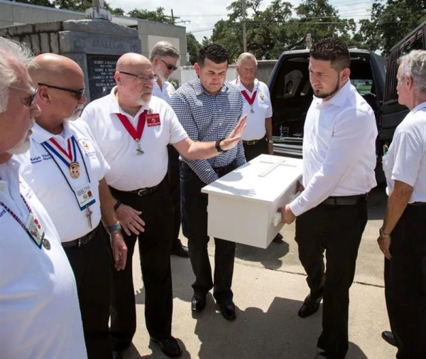 A father (right) whose child was murdered carries the casket with the help of others. Credit: Photo courtesy of Compassionate Burials for Indigent Babies