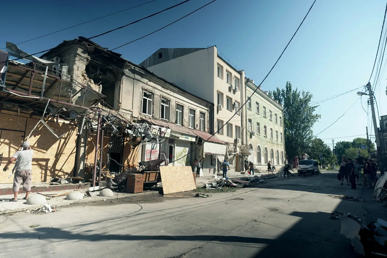TOPSHOT - A local resident clear the rubbles of his destroyed following Russian missiles strike in Kherson on August 14, 2023, amid Russian invasion in Ukraine. (Photo by Alexei Sandakov / AFP) (Photo by ALEXEI SANDAKOV/AFP via Getty Images)
