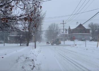 In Wisconsin, crews restoring power while Iowa airport tries to reopen after plane left icy runway